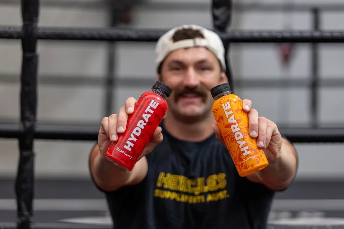 Someone holding up two bottles of Hydrate